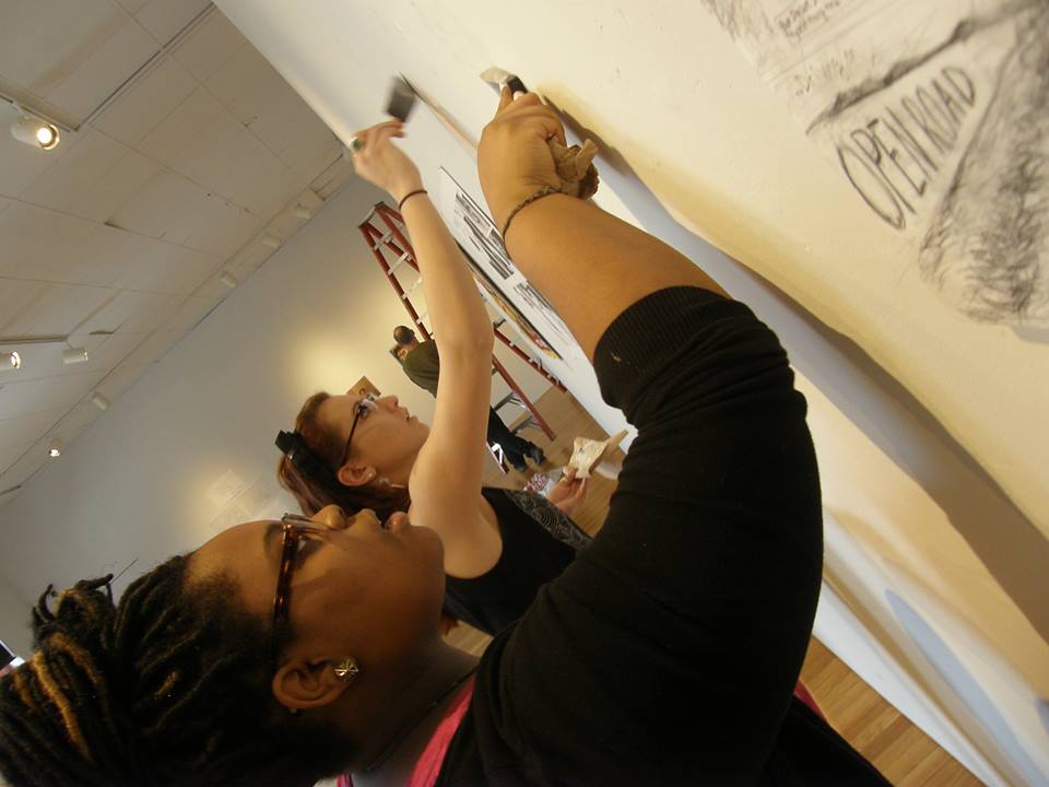 My freshman mentee and I prepping the gallery walls for the Fusion: Academic Compass Exhibit in the Brandt Gallery.