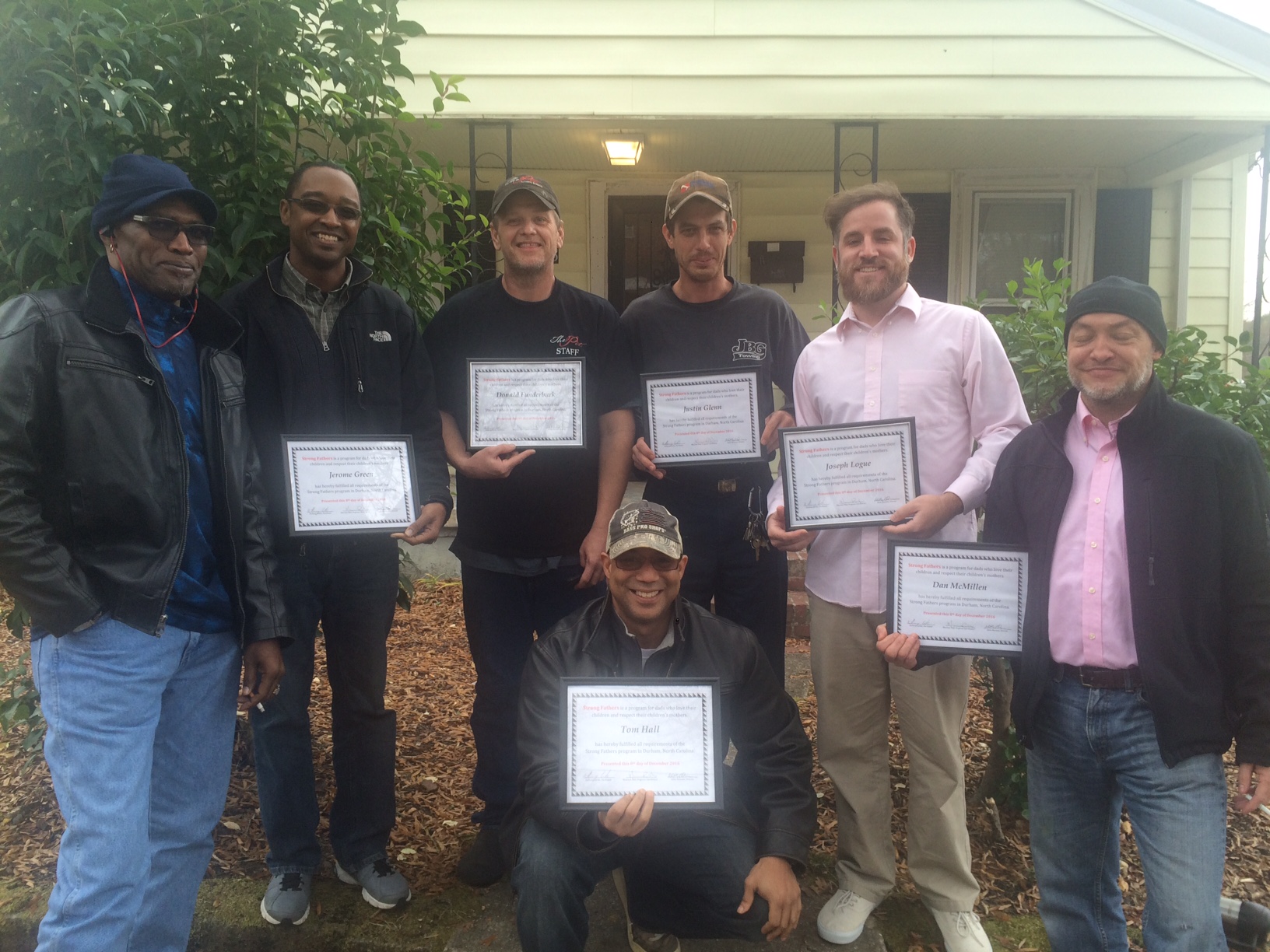 Graduates with their certificates