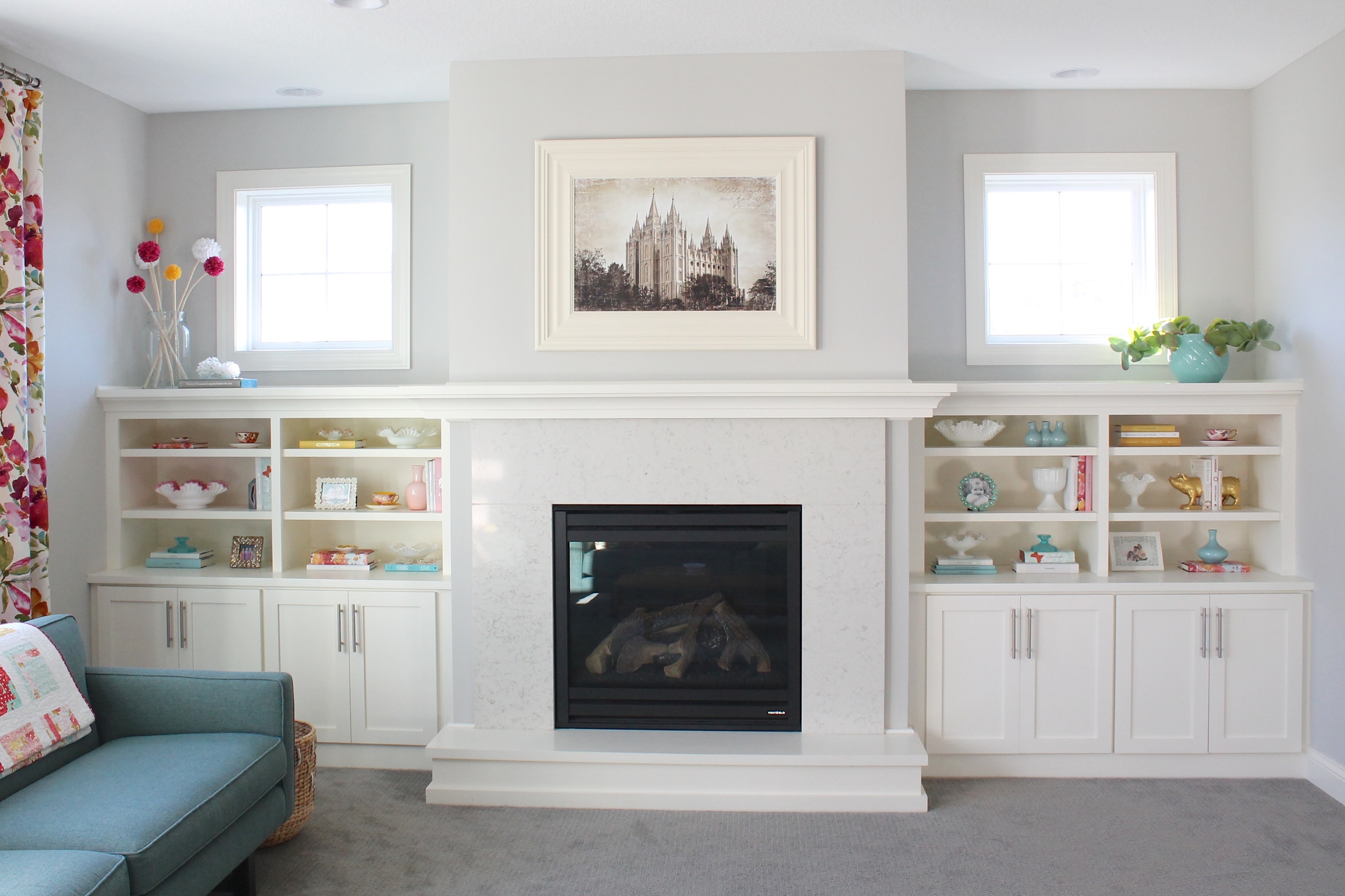 Built in bookshelf decorating ideas. Style a bookshelf with a cohesive color pallet by covering books with pretty paper. Add some glass objects and small frames to round out the design.