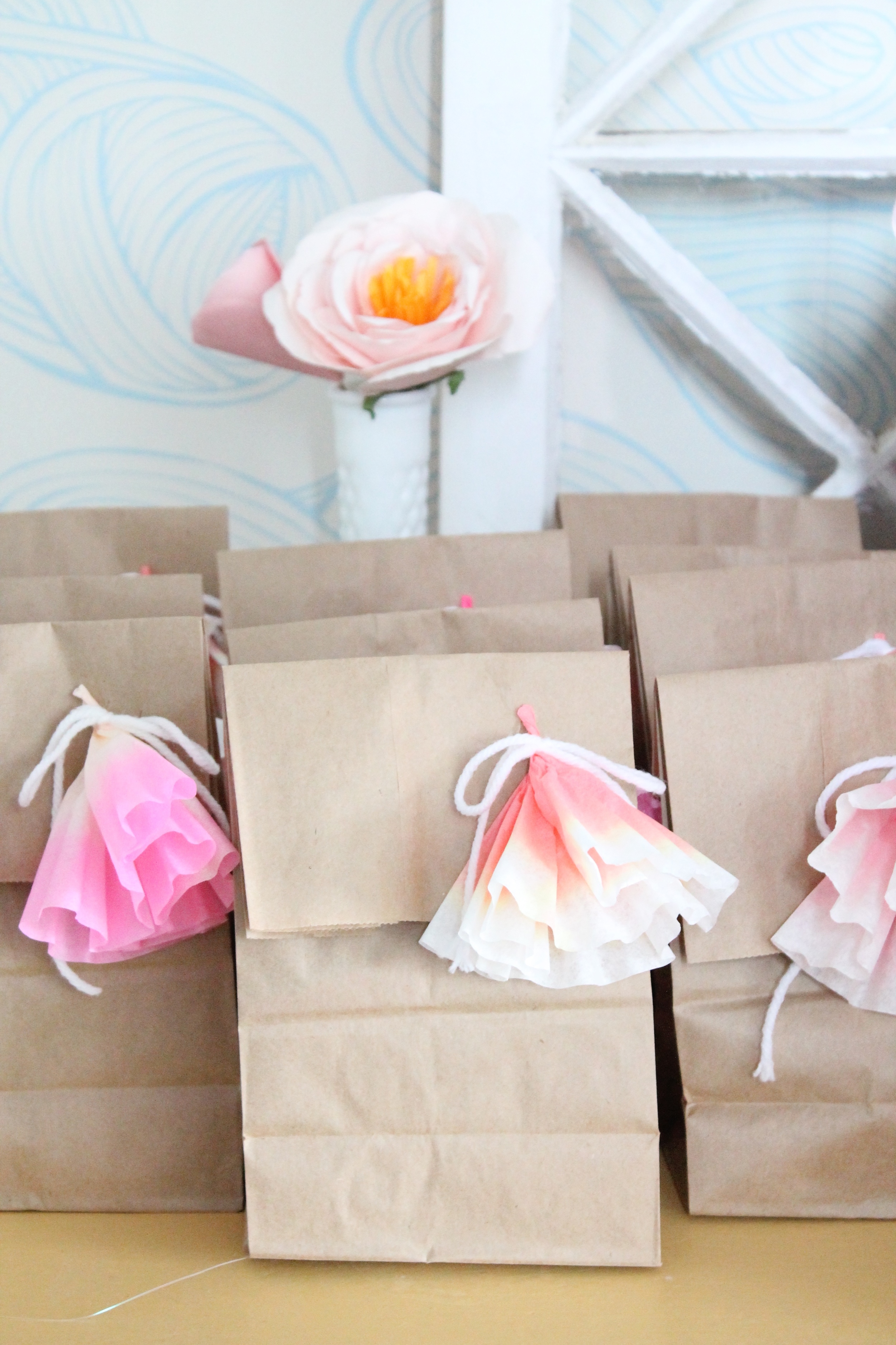 Adorable goodie bag idea for a garden tea party. Made with brown lunch sacks and coffee filter flowers.