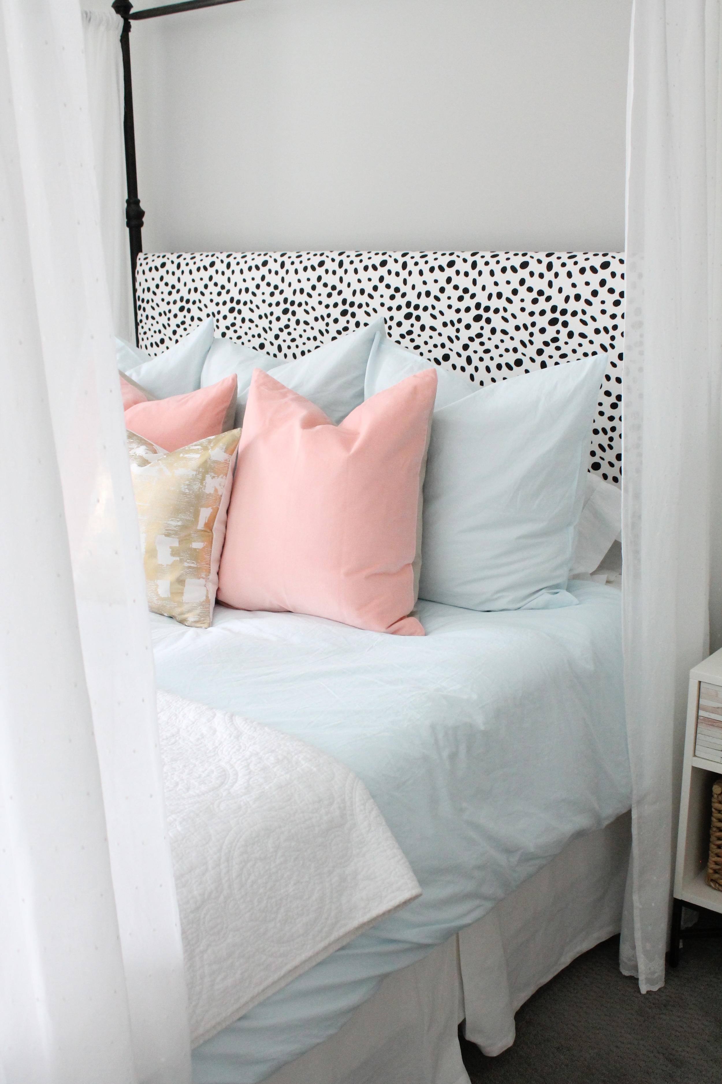 Lovely Master Bedroom. Canopy bed with dalmatian headboard. Pink and blue bedding with a touch of gold.