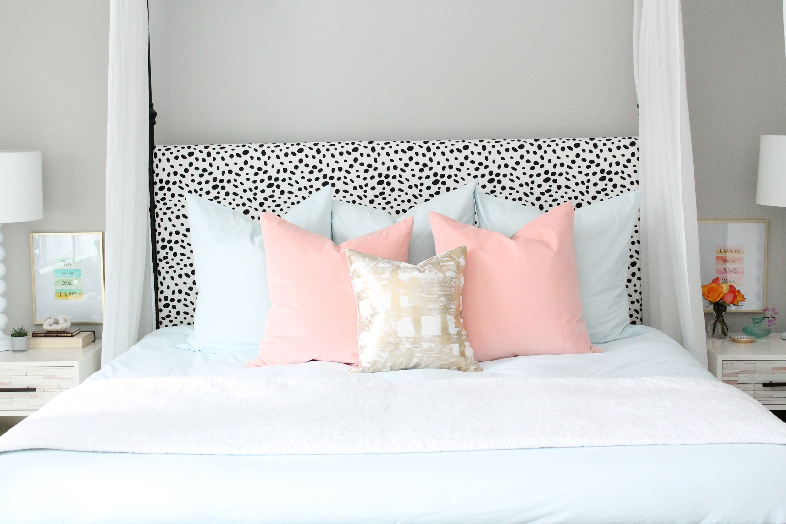 Lovely Master Bedroom. Canopy bed with dalmatian headboard. Pink and blue bedding with a touch of gold.