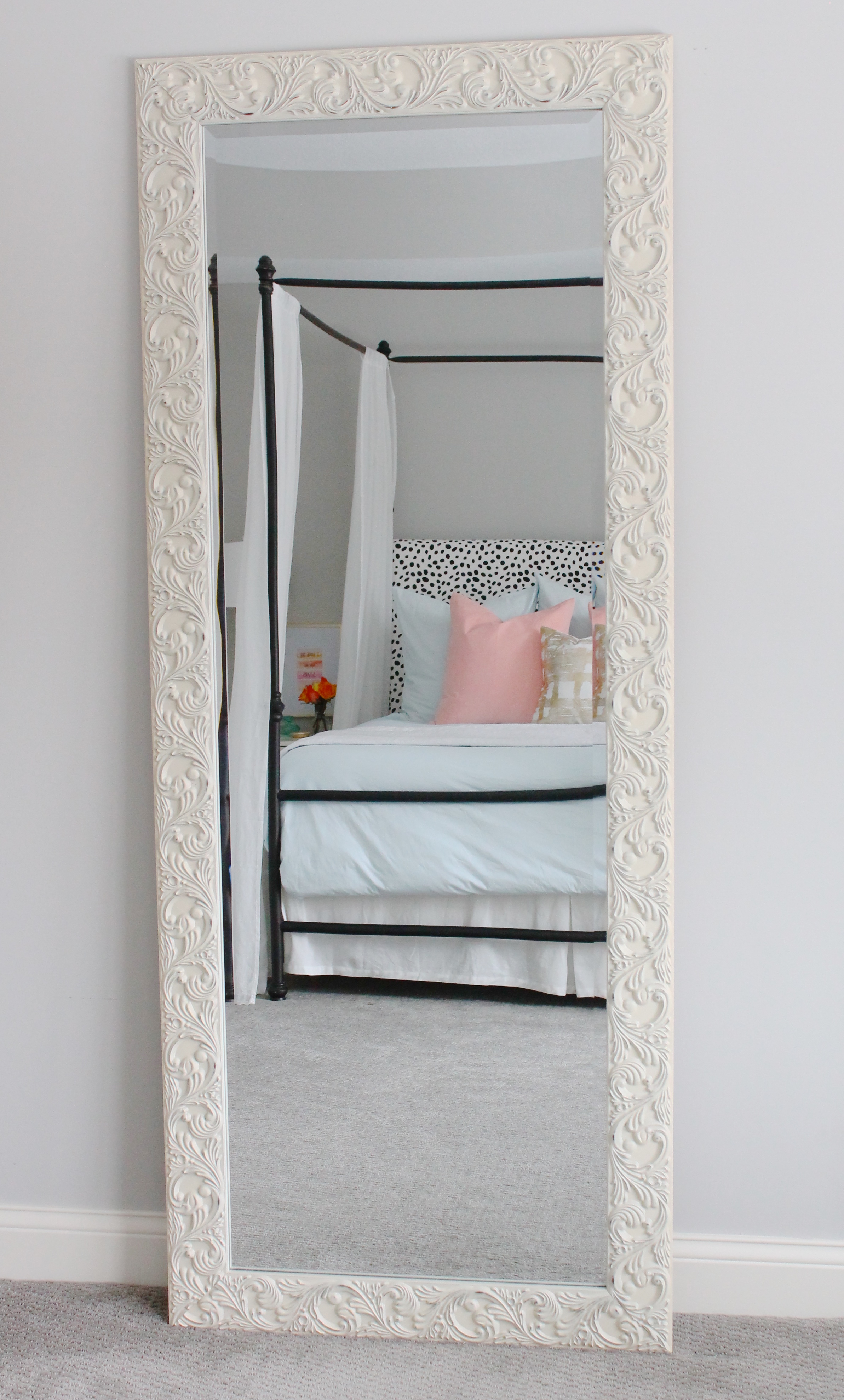 Lovely master bedroom with leaner mirror, pink and blue bedding and a dalmatian headboard.
