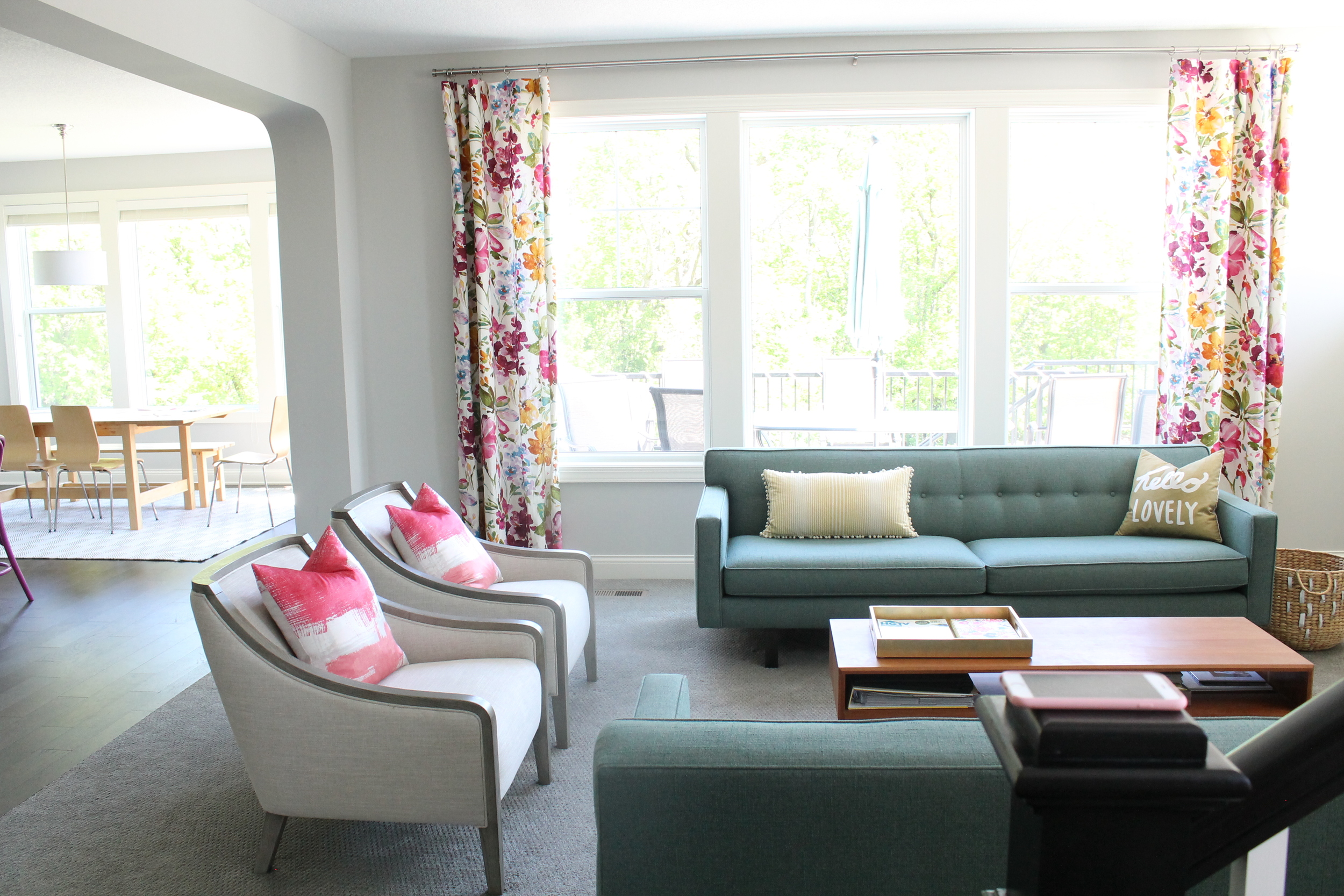 Family Room from Tessie Fay. Love the floral curtains and pops of color.