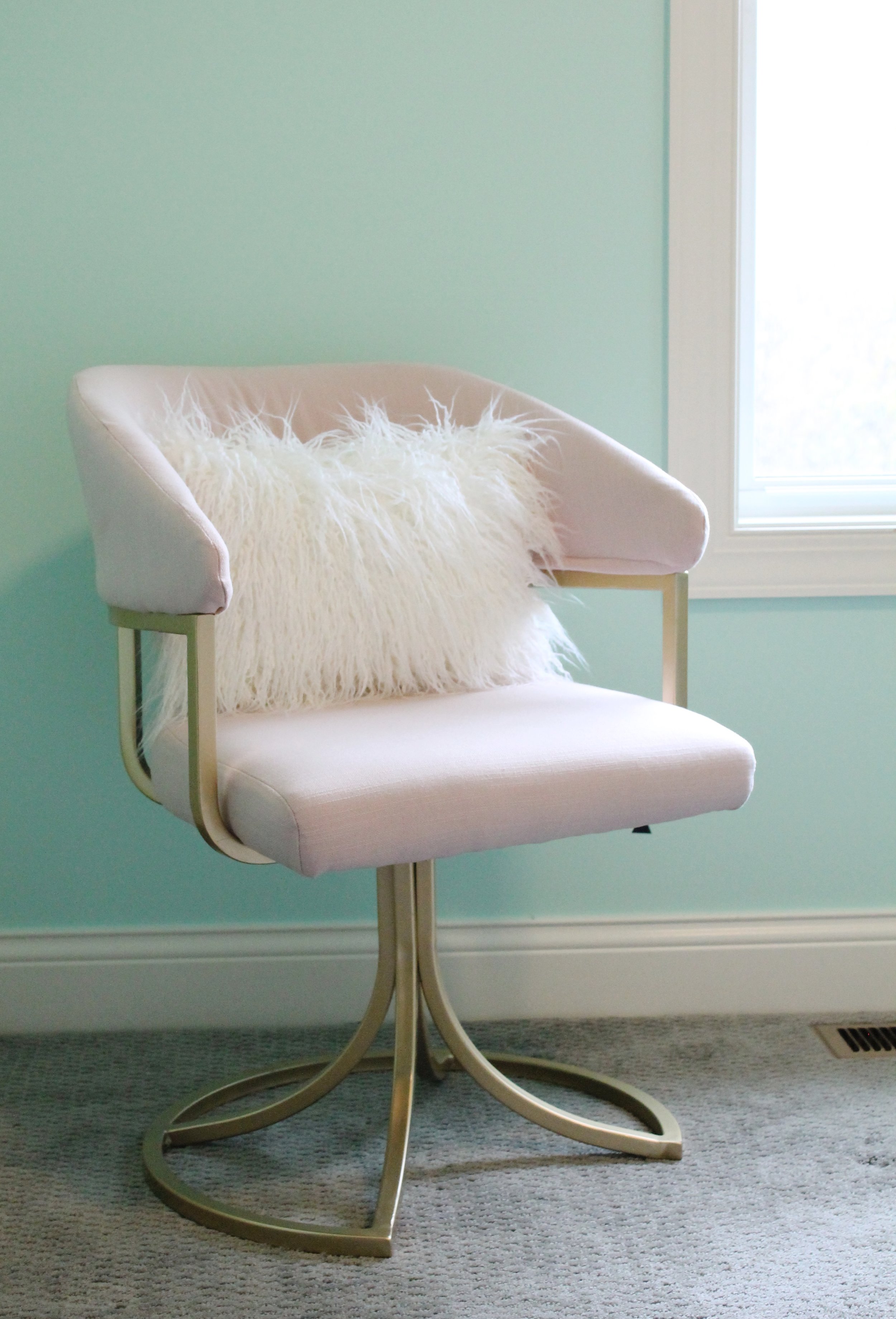 Pink and Gold Chair with mint walls.