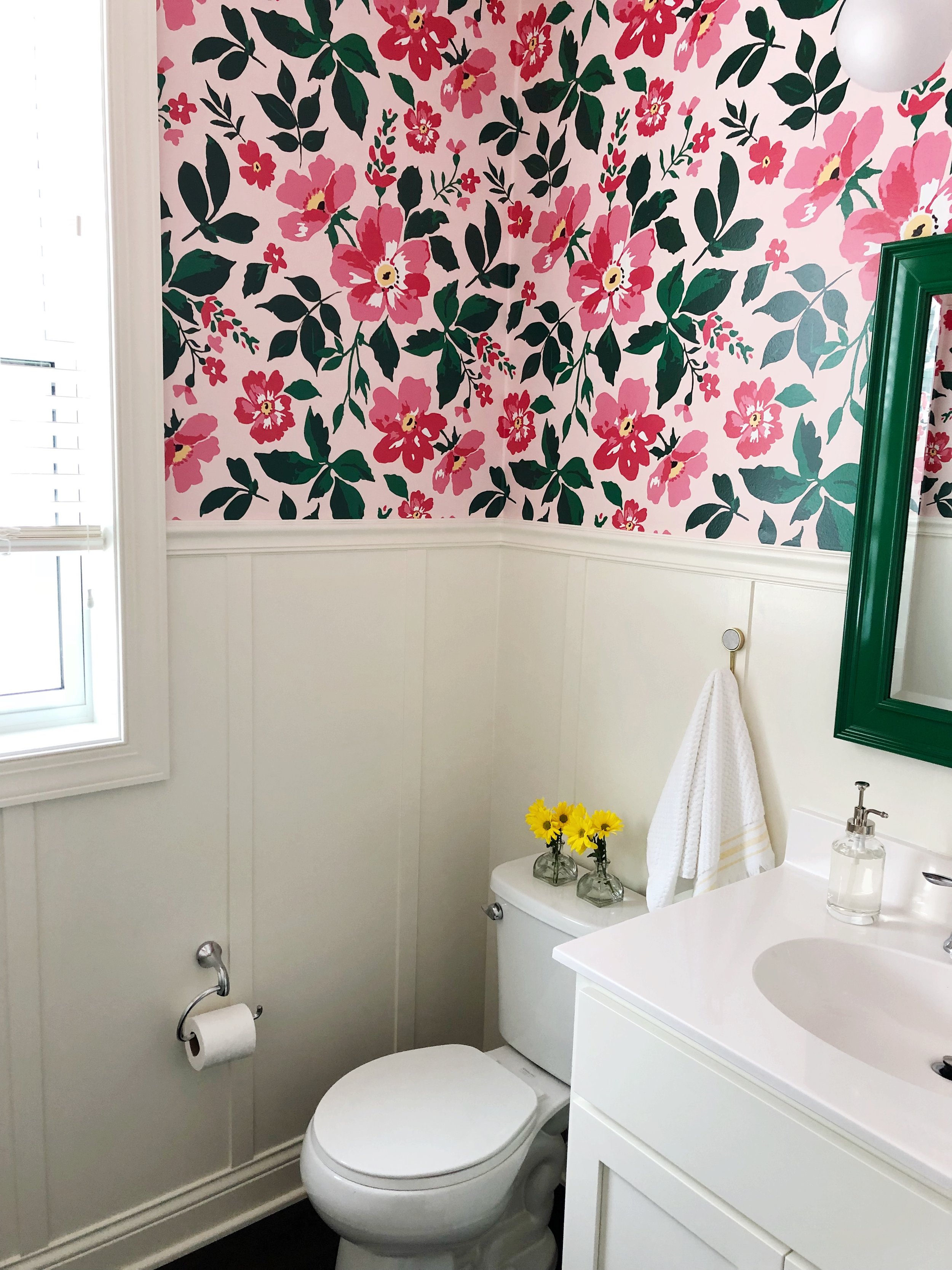 Bathroom makeover with custom wallpaper and DIY Board and Batten. Pink and Green Powder Room.