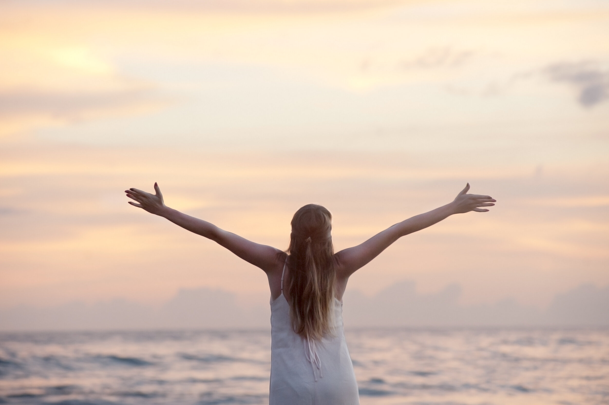 woman-by-the-sea-with-streched-arms-320007.jpeg