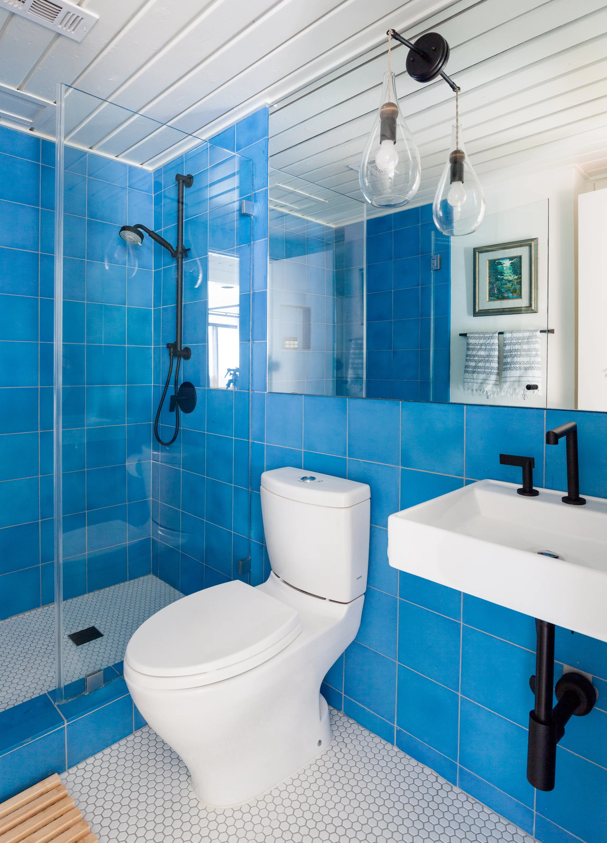 ERIN WILLIAMSON | OKENA BLUE CEMENT TILE BATHROOM RENOVATION SMALL SPACE BLACK PLUMBING