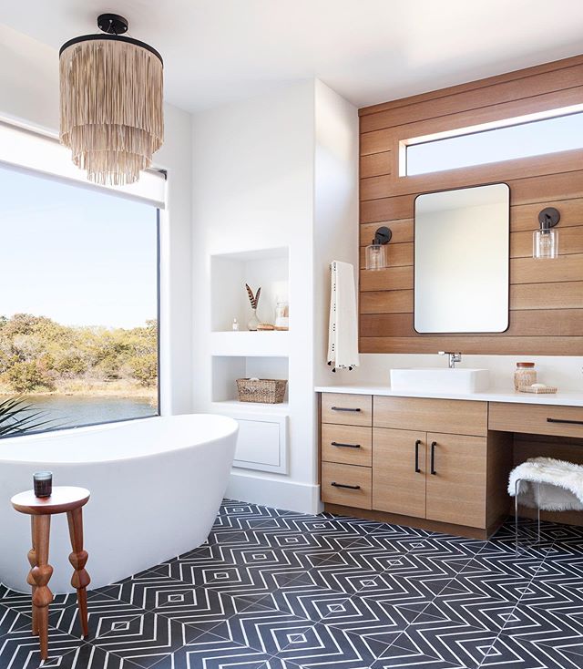 Organic modern master bath on the lake from our fun and funky #wildernesslakehouse project ✨ We moved heaven and earth (and a lot of walls) to get our uber awesome clients the vacation home of their dreams. You could do cartwheels in the mega giant d