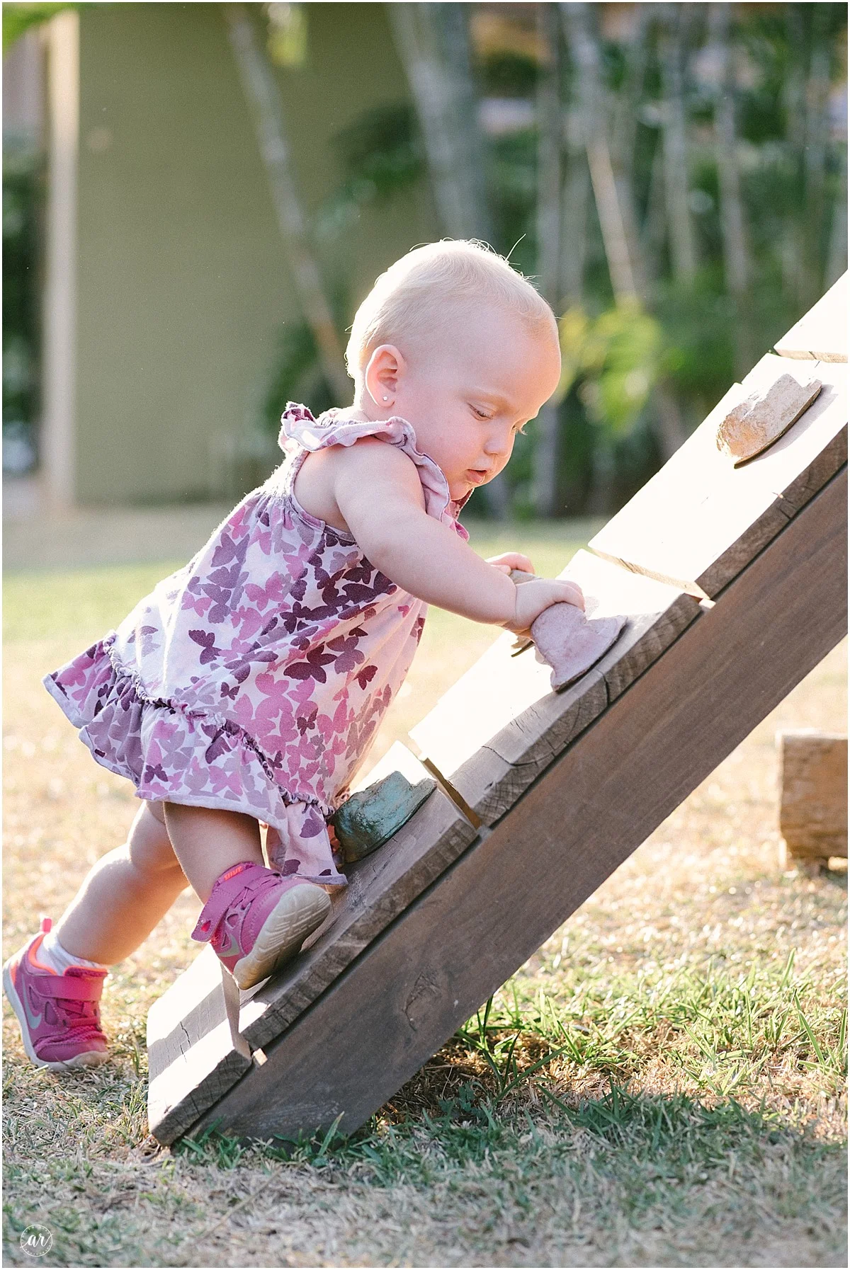 Kenzie is climbin. I don't think she's allowed to climb. I don't know about that. Is she a big girl, or a baby? Why is she climbing on herself? 