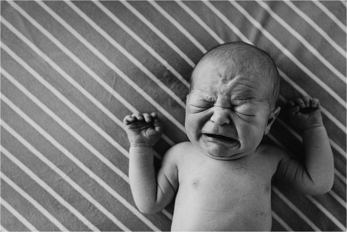 Baby boy crying on blanket during his first photo shoot | Orlando Fresh 48 Newborn Photographer
