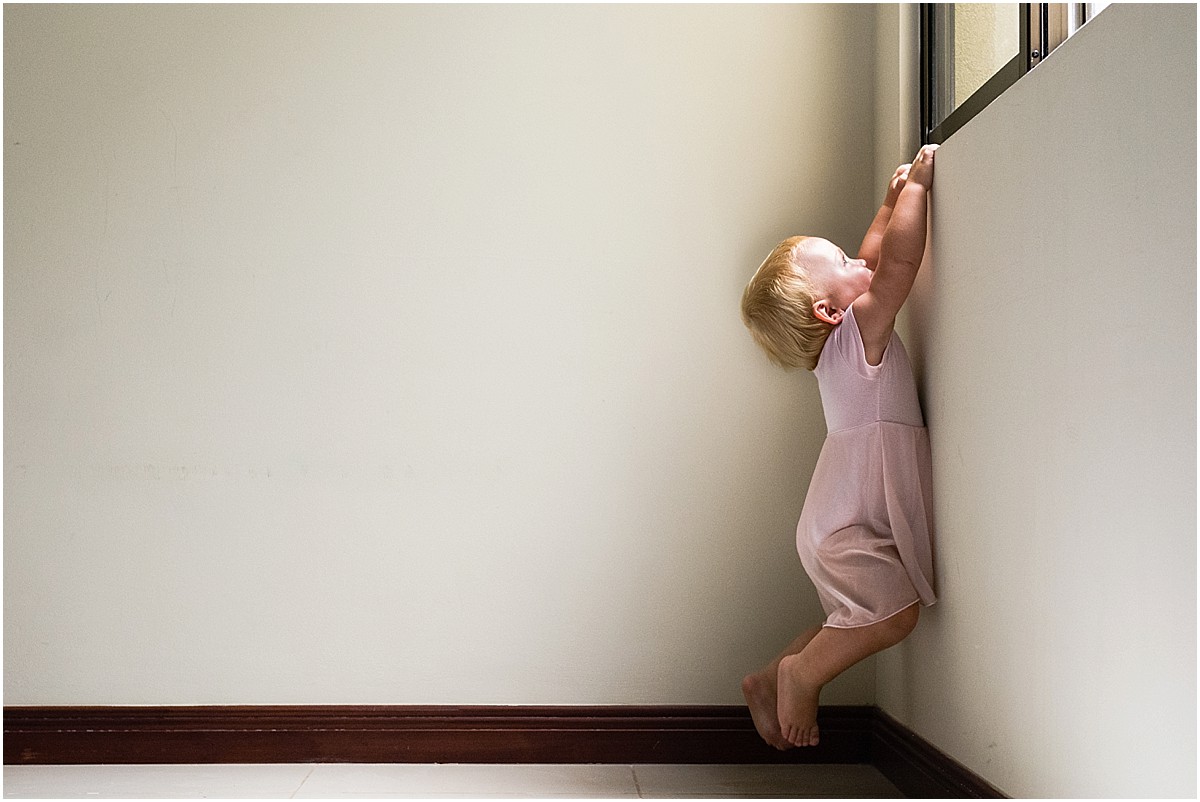 Ballerina baby climbing up a window in Costa Rica house