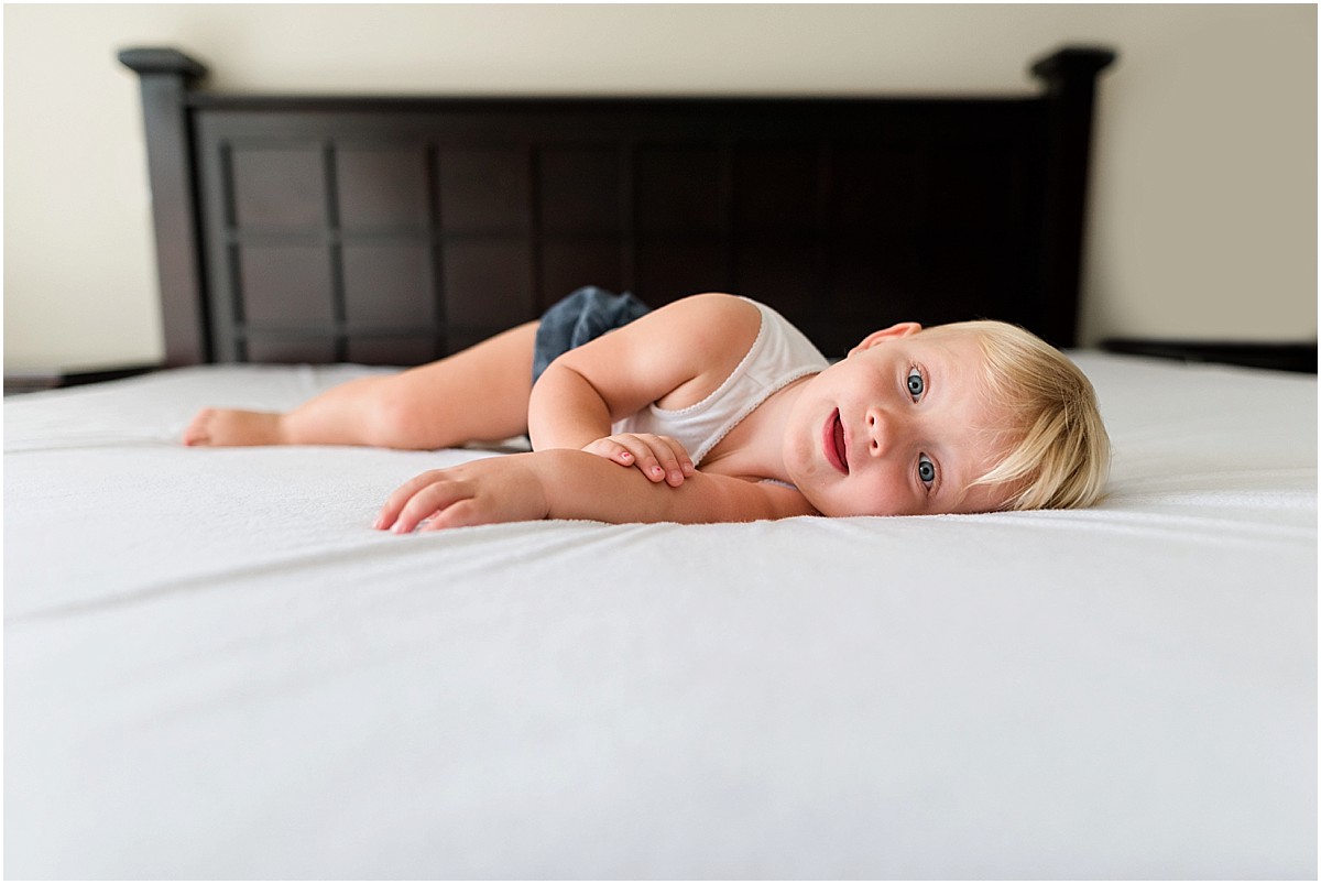 One year old baby girl laying in bed