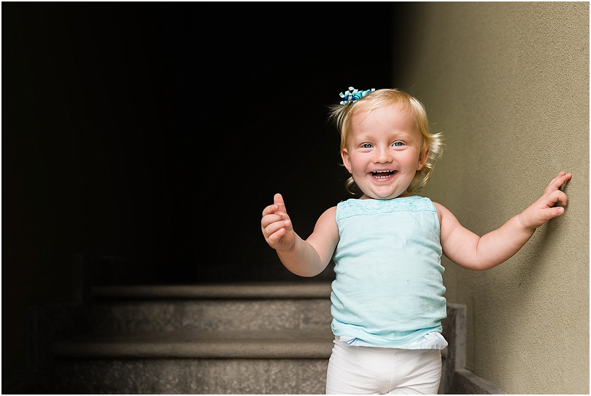 Little girl smiling on the neighborhood steps in Santa Ana, Costa Rica