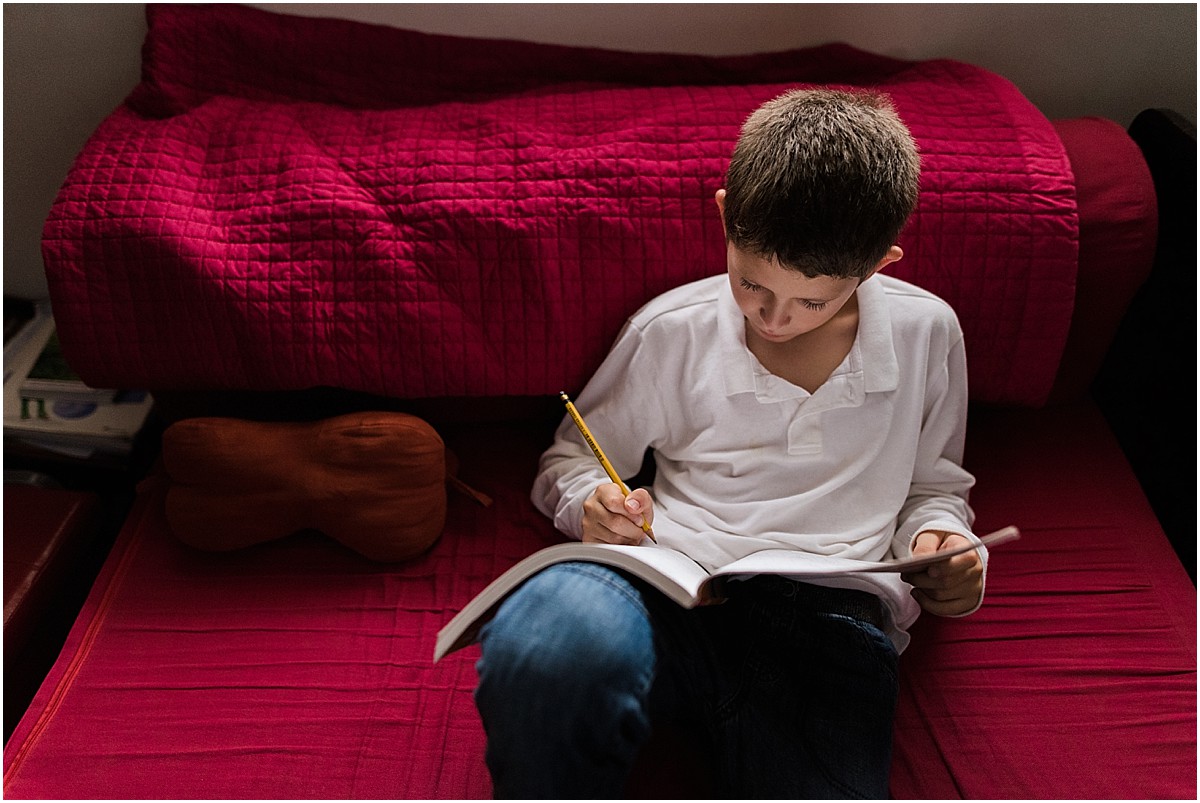 little boy doing homework during lifestyle photoshoot in Costa Rica