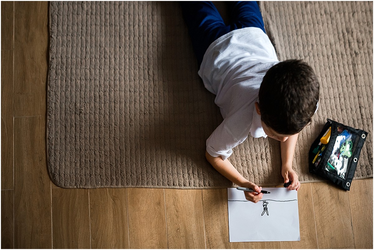 little boy drawing pictures during documentary family photoshoot in Costa Rica