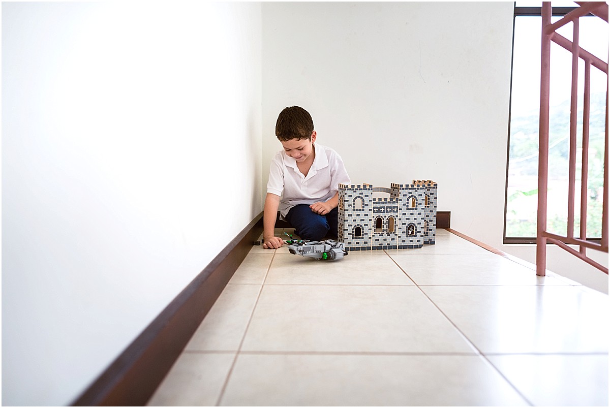 little boy playing with legos in his house in Costa Rica