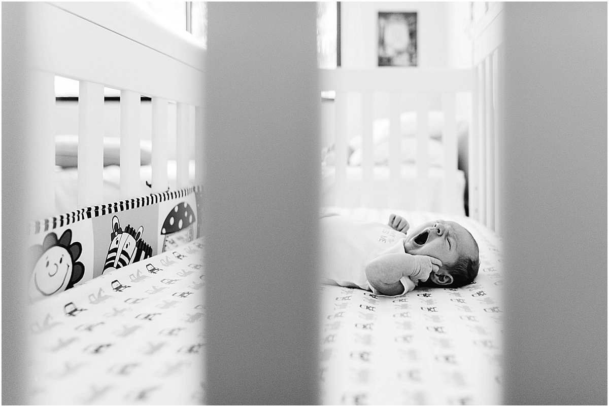 Newborn baby yawning in his crib | Central Florida lifestyle newborn photography
