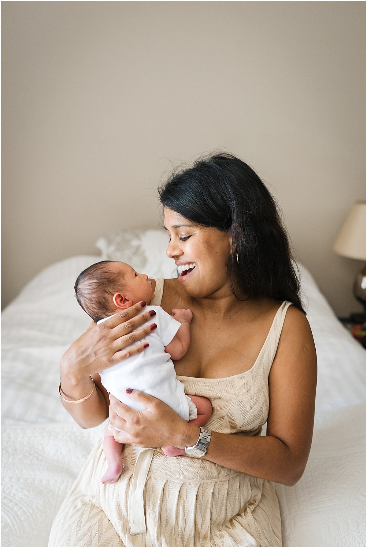 mom looking at her newborn baby boy during in-home newborn photography session | Orlando newborn photographer