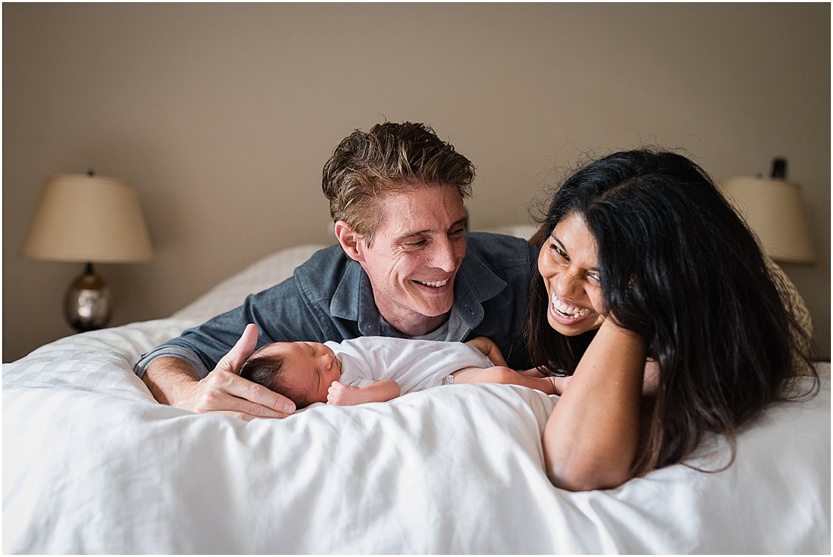 family laughing during in-home newborn photography session | Orlando newborn photographer