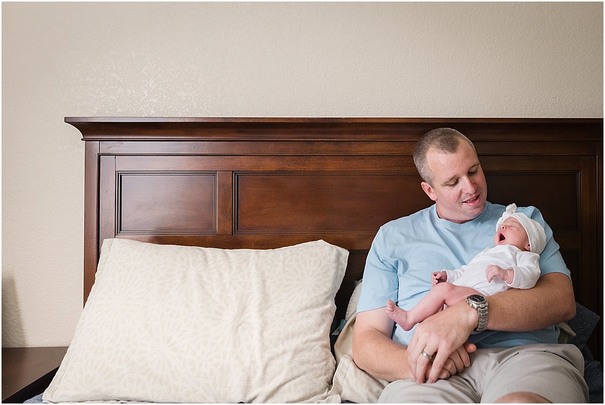Dad with baby girl yawning | Central Florida Newborn Photographer