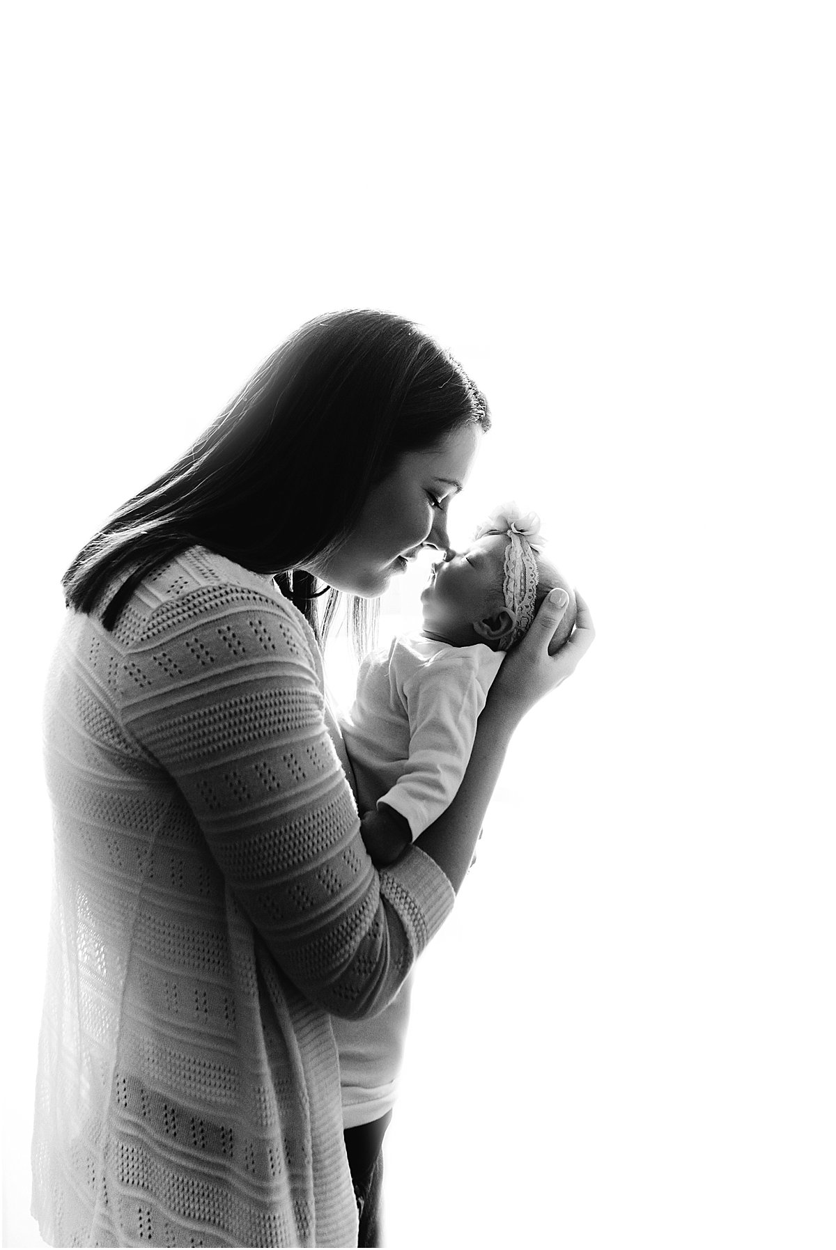 mom kissing newborn baby girl | Orlando lifestyle newborn photographer