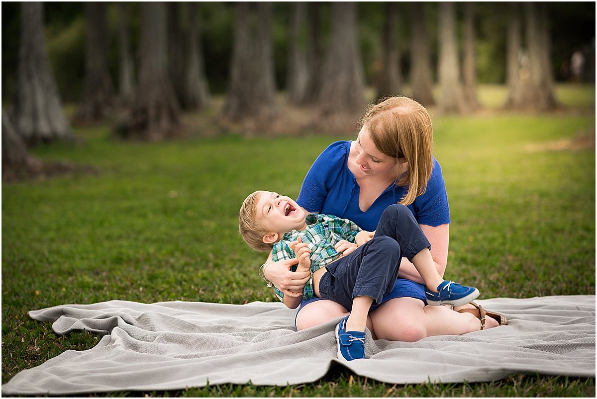  mom and son giggling during family photos 