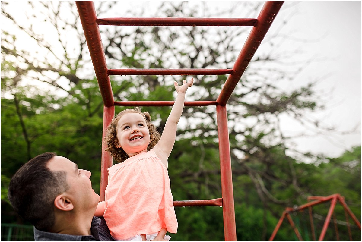 Dad helping his daughter on monkey bars | Orlando lifestyle photographer