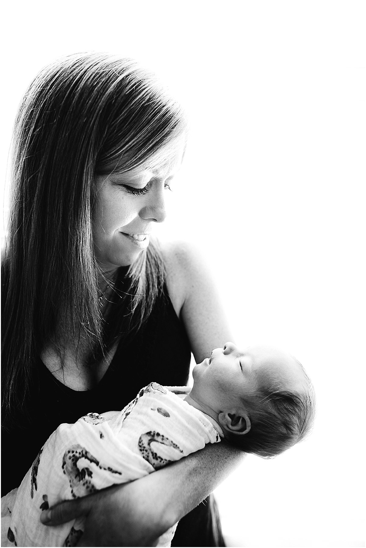 mom admiring newborn baby | orlando newborn photographer