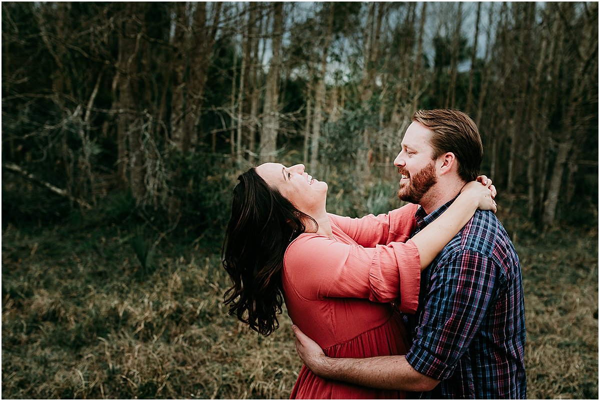 Expecting couple laughing during maternity photos | Orlando newborn photographer