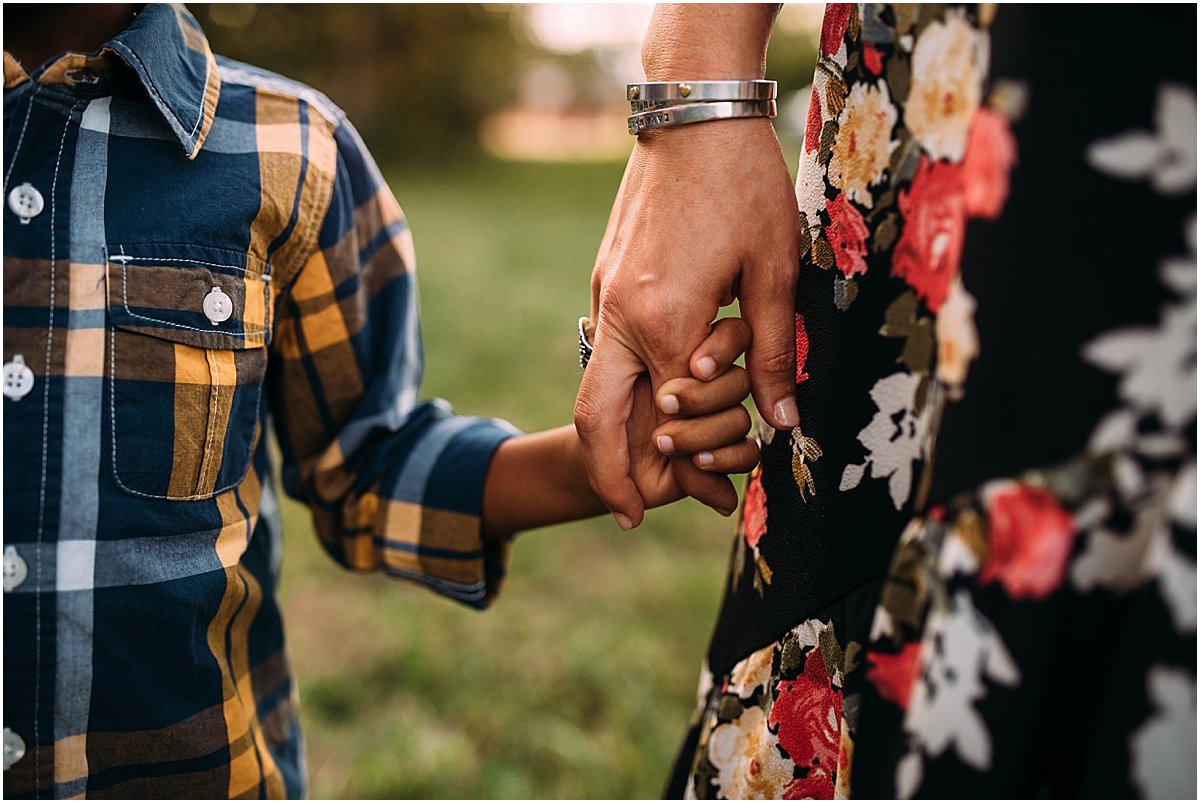 mom holding son's hand during family photos in Orlando, Florida