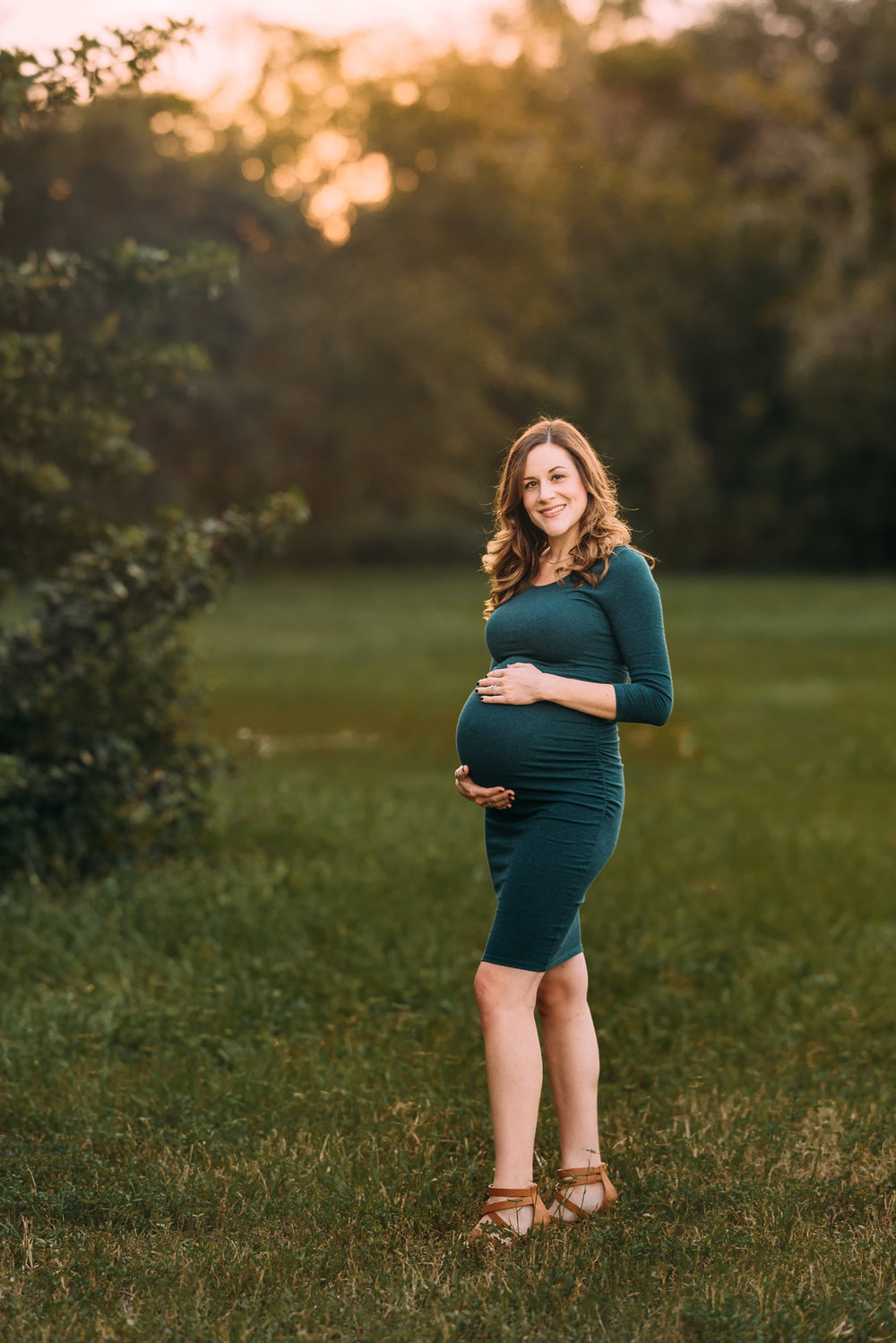 Pregnant mom holding baby bump | Oviedo family photographer