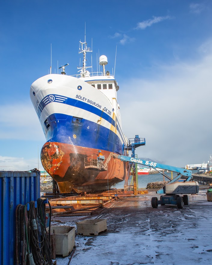 Power-washing Icelandic trawler, Soley Sigurjons in Reykjavic harbor.