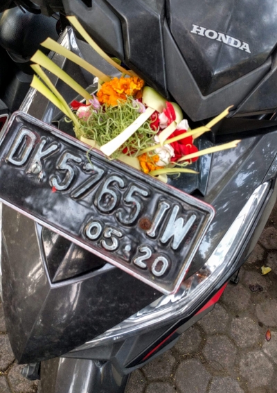 The motorbike I rode around for a month, adorned with an offering on my visit to the temple. It fell off.
