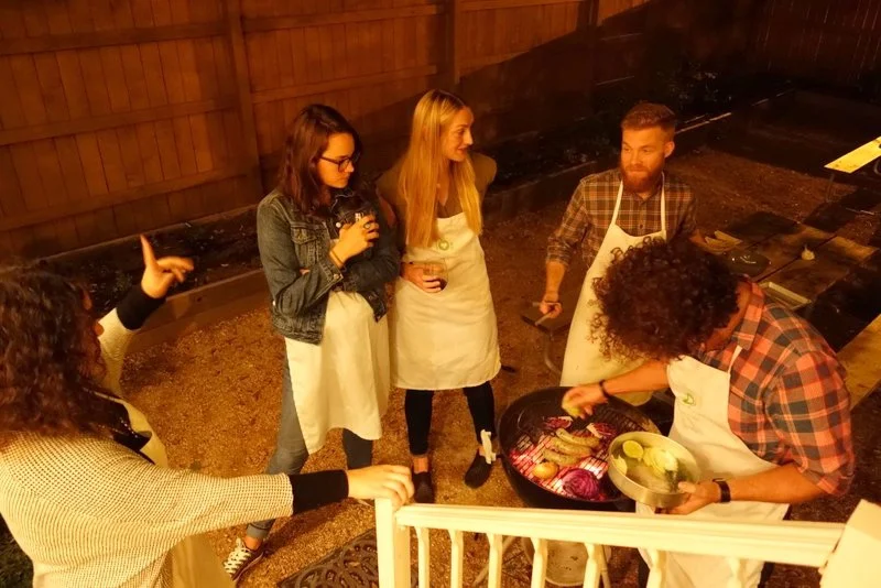 A team utilizing the grill for their appetizer round creation (Mystery Ingredients: Sausage, Pita Wrap, Rutabega Puree, Arugula)