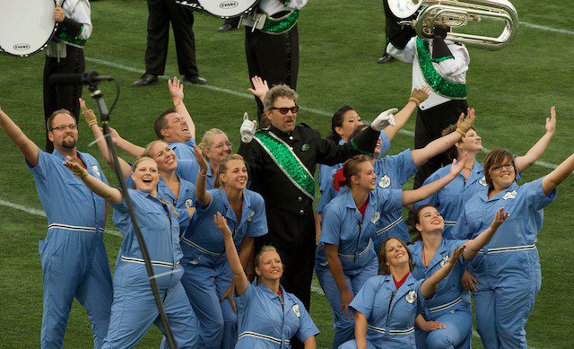  From the field in 2010, Govenaires Drum Major John Mayer and the colorguard celebrate being "the oldest competing drum and bugle corps in the world!" 