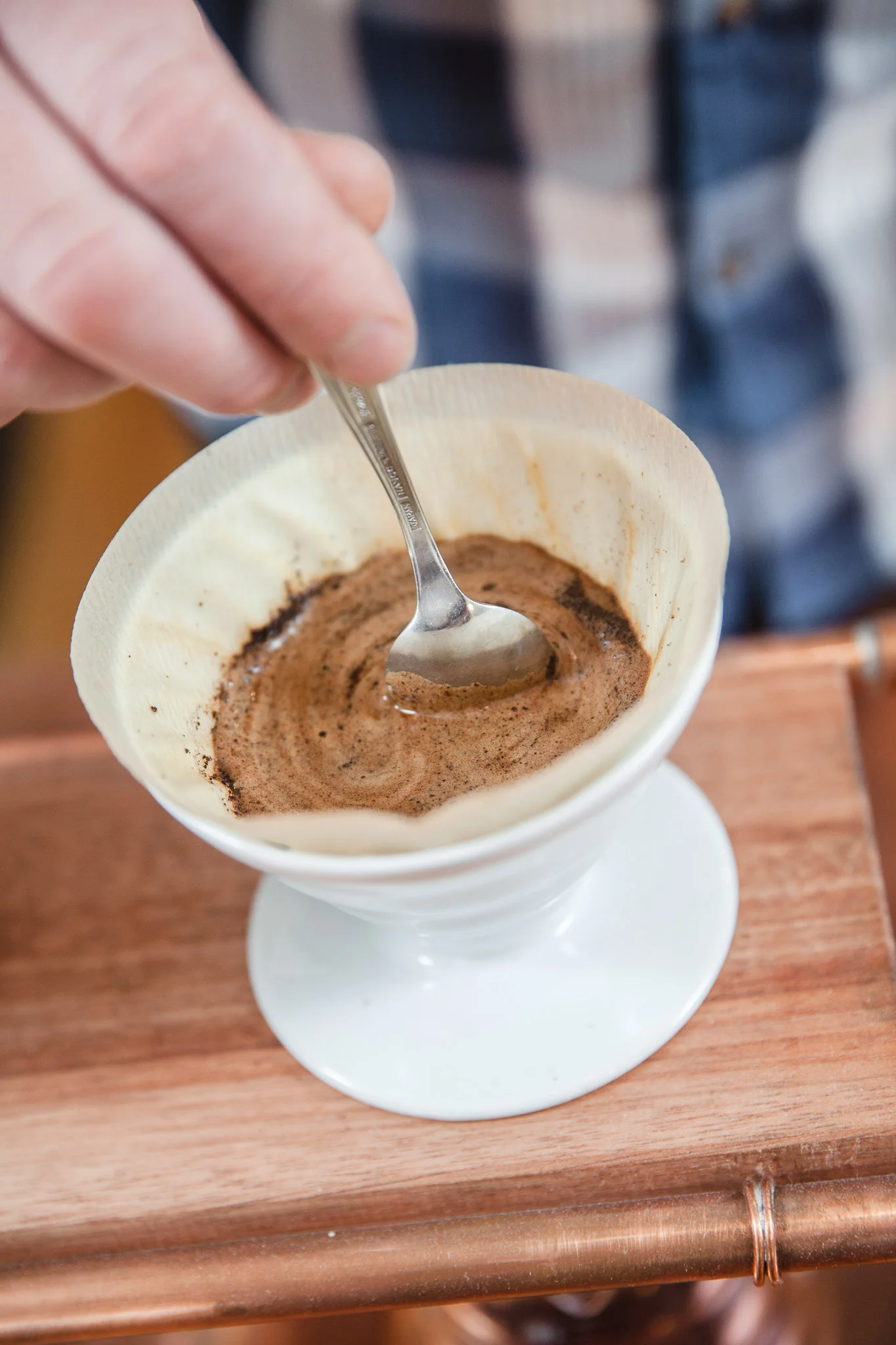 7. Take a spoon and slowly stir the grounds off of the sides so they settle evenly.