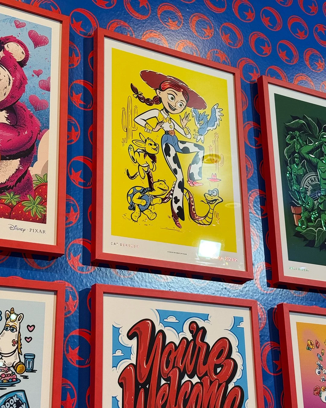 Colorful framed poster featuring Jessie from Toy Story with her cowgirl friends and Reed, the snake, on a yellow background.
