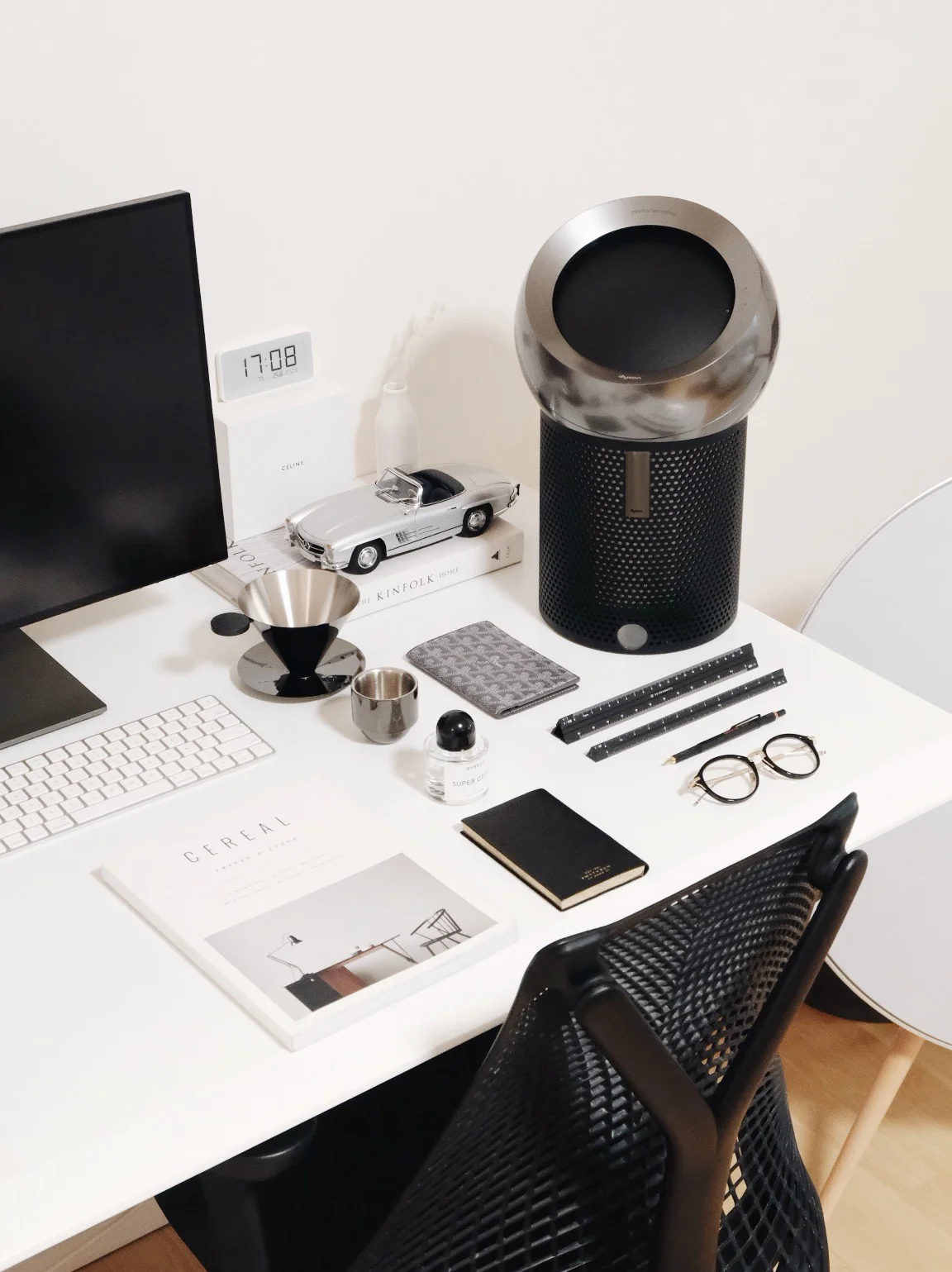 Sitting stylishly on the desk.