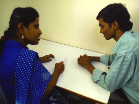 A male factory worker being surveyed for quantitative research