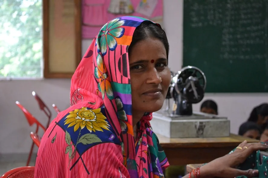 A female student learns vocational skills to support her sick husband. Her daughter is on full scholarship at the Dayawanti Punj Model School next door.