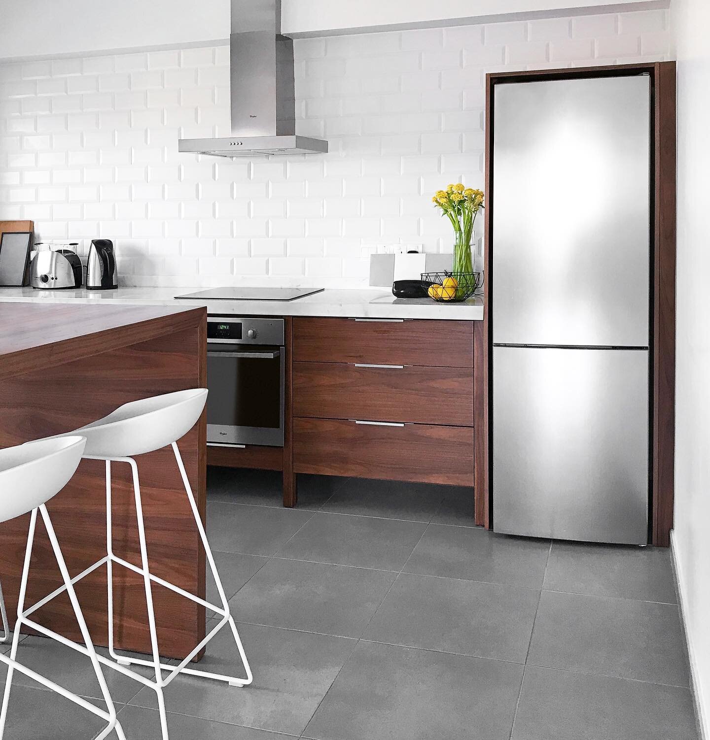 A collaboration with my boyfriend Markos for his Cyprus apartment. Custom walnut millwork, white marble countertop, and matte white subway tile....And yes He paid his design fees with hugs and kisses 😘. Stools by @haydesign . #walnut #kitchendesign 