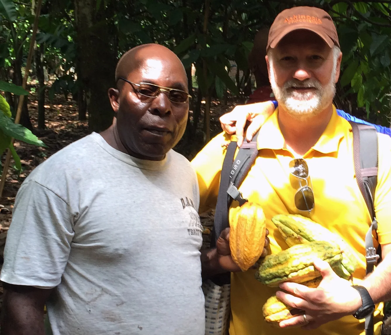 Livingston and Shawn gathering cocoa pods