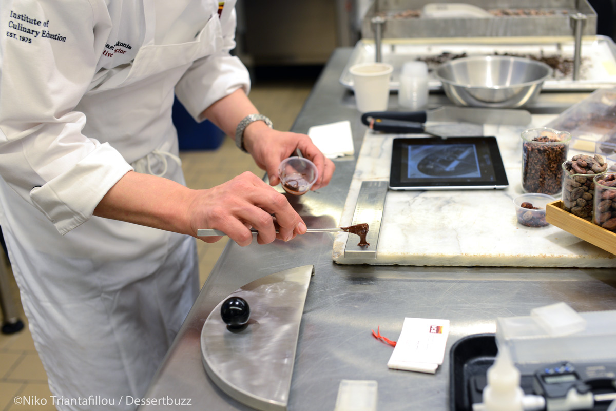 Michael Laiskonis measuring the size of the particles in semi-refined chocolate. Photo courtesy Niko Triantafillou/Dessertbuzz