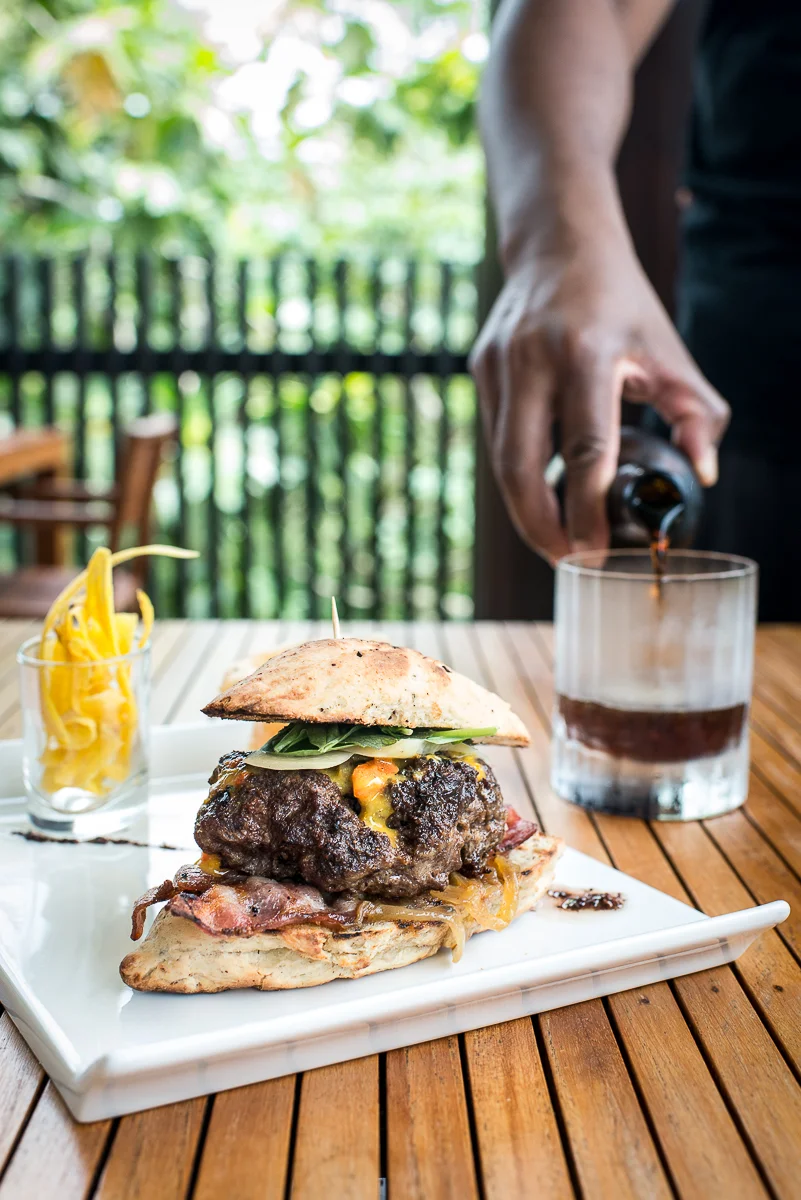 Everything relates back to chocolate at Hotel Chocolat, even the burger. The bun is shaped like a cacao pod, and the burger is made with cacao nibs and served with a cacao nib vinaigrette on the side. Meanwhile the porter is made with cacao shells. Photo by Jenny Sathngam