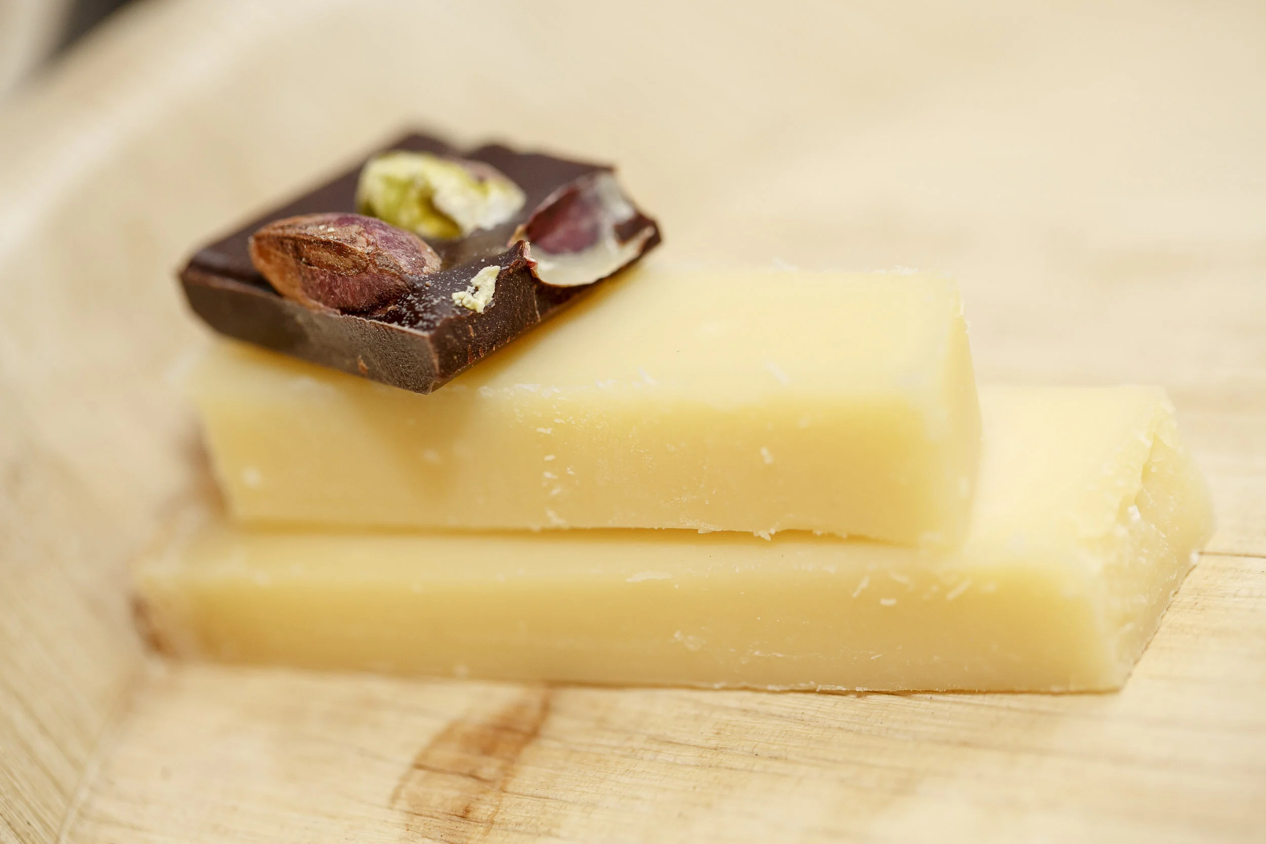 Pistachio chocolate square on top of cheese