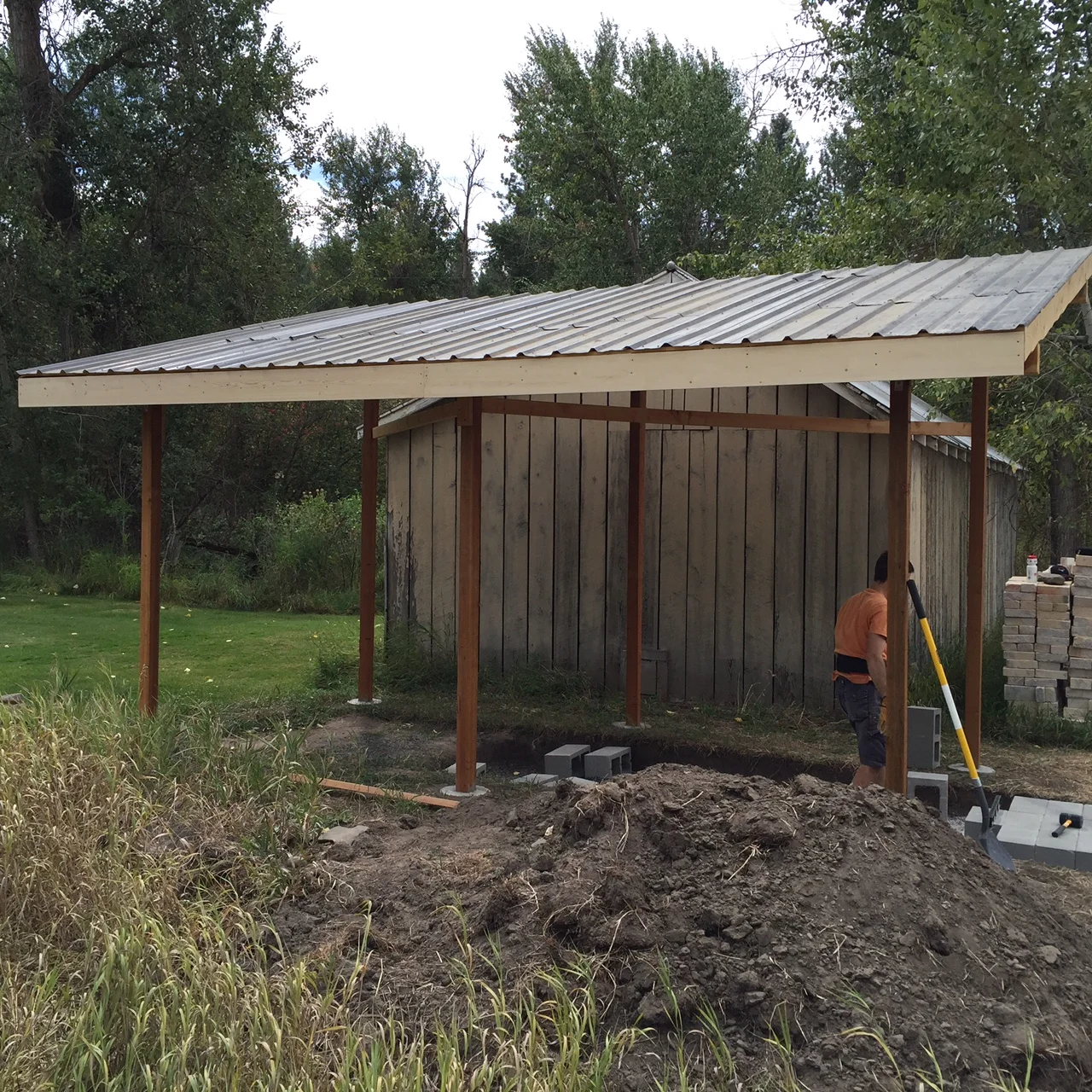  Laying CMU's on a bed of gravel for the foundation. (concrete masonry units) approx .6x13ft. 