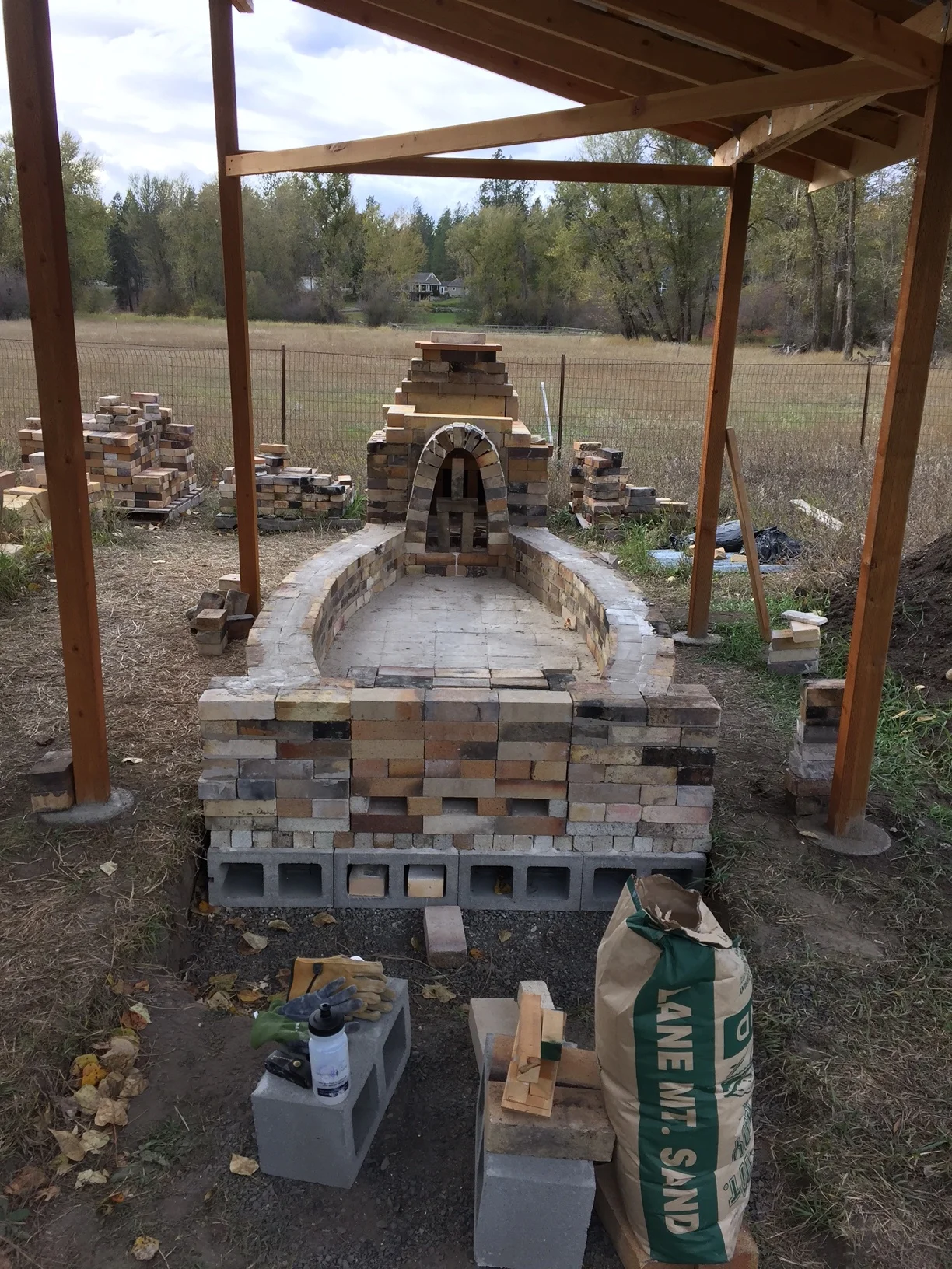  The 'mortar' is a slurry of fireclay and 70 mesh silica sand. Each brick is dipped before placement. 