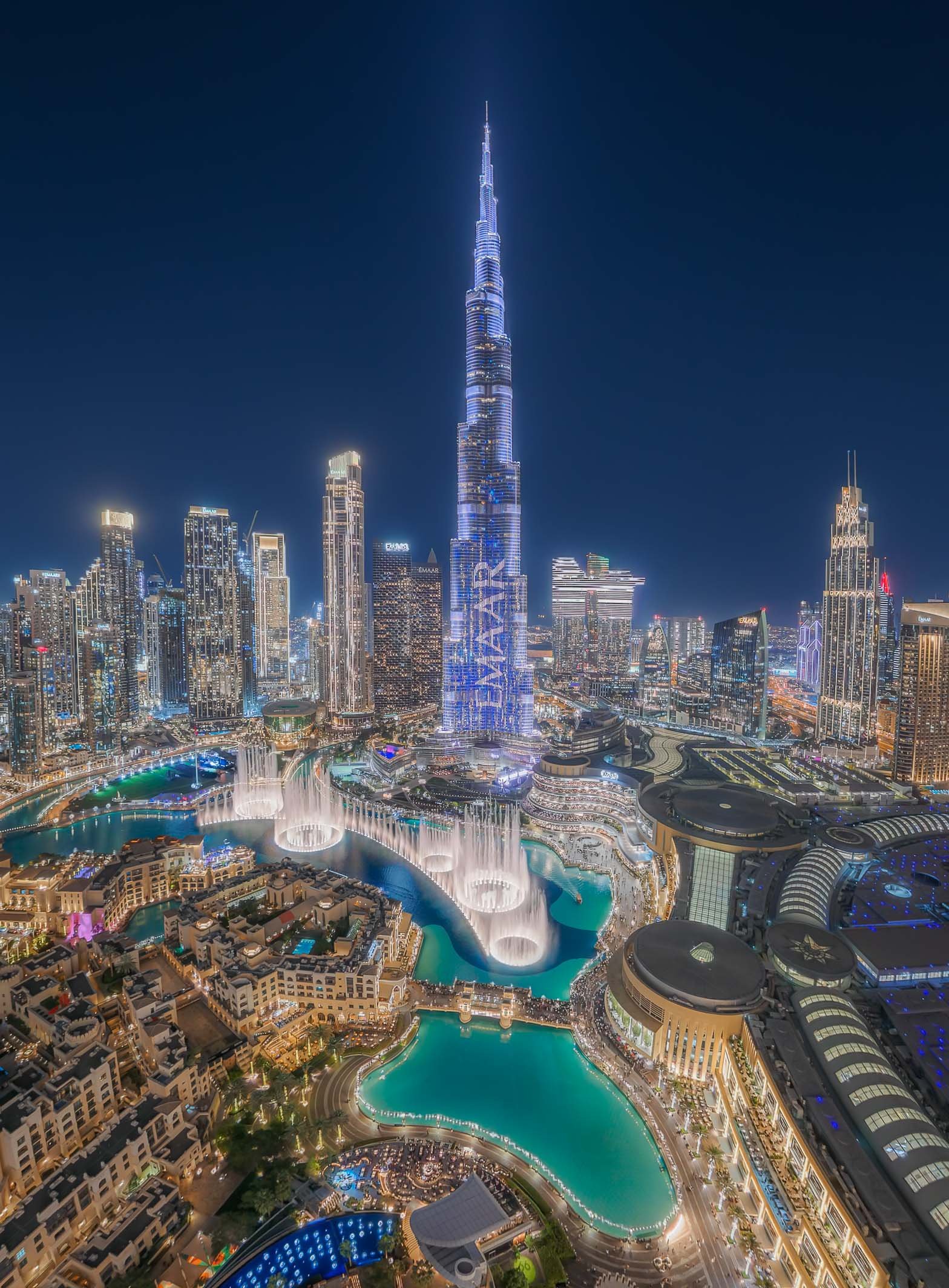  Cityscape 
 Iconic 
A super wide angle view of the Burj Khalifa and surrounding Downtown Dubai while the Dubai Fountain performs. 