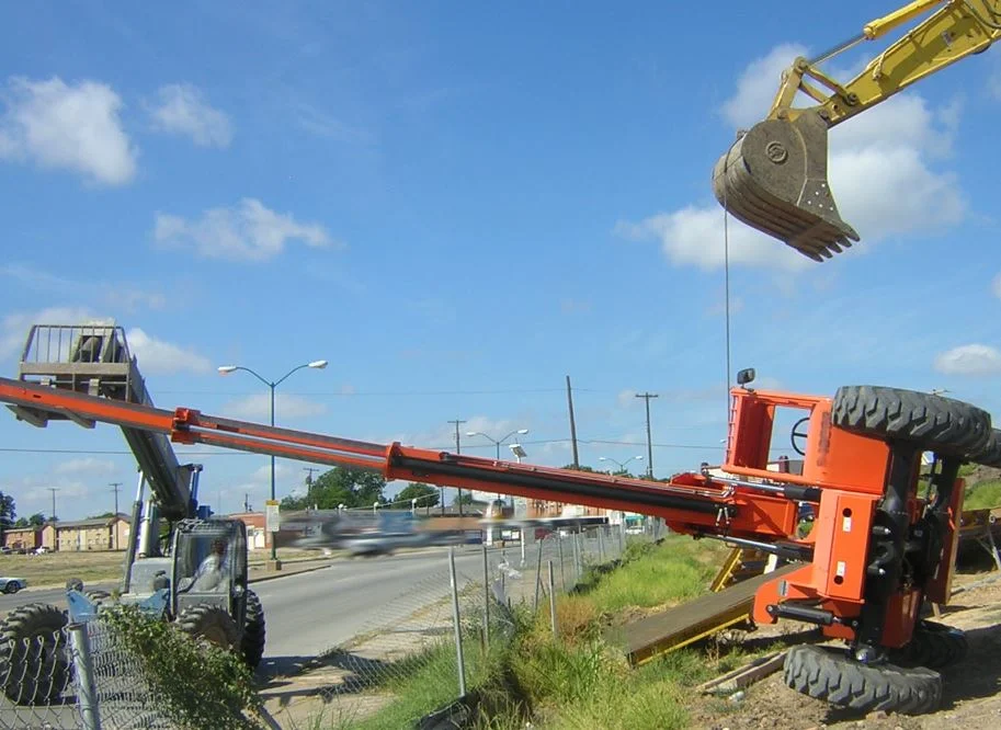 Two additional pieces of heavy equipment attempt to upright this forklift after the operator tipped it over. Fortunately, no one was injured in this incident.